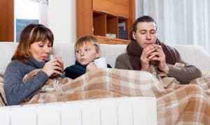 family warming near radiator