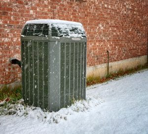 air conditioner under falling snow