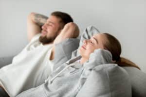 couple resting on sofa