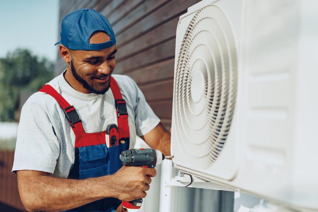 Repairman installing air conditioner