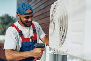 Repairman installing air conditioner